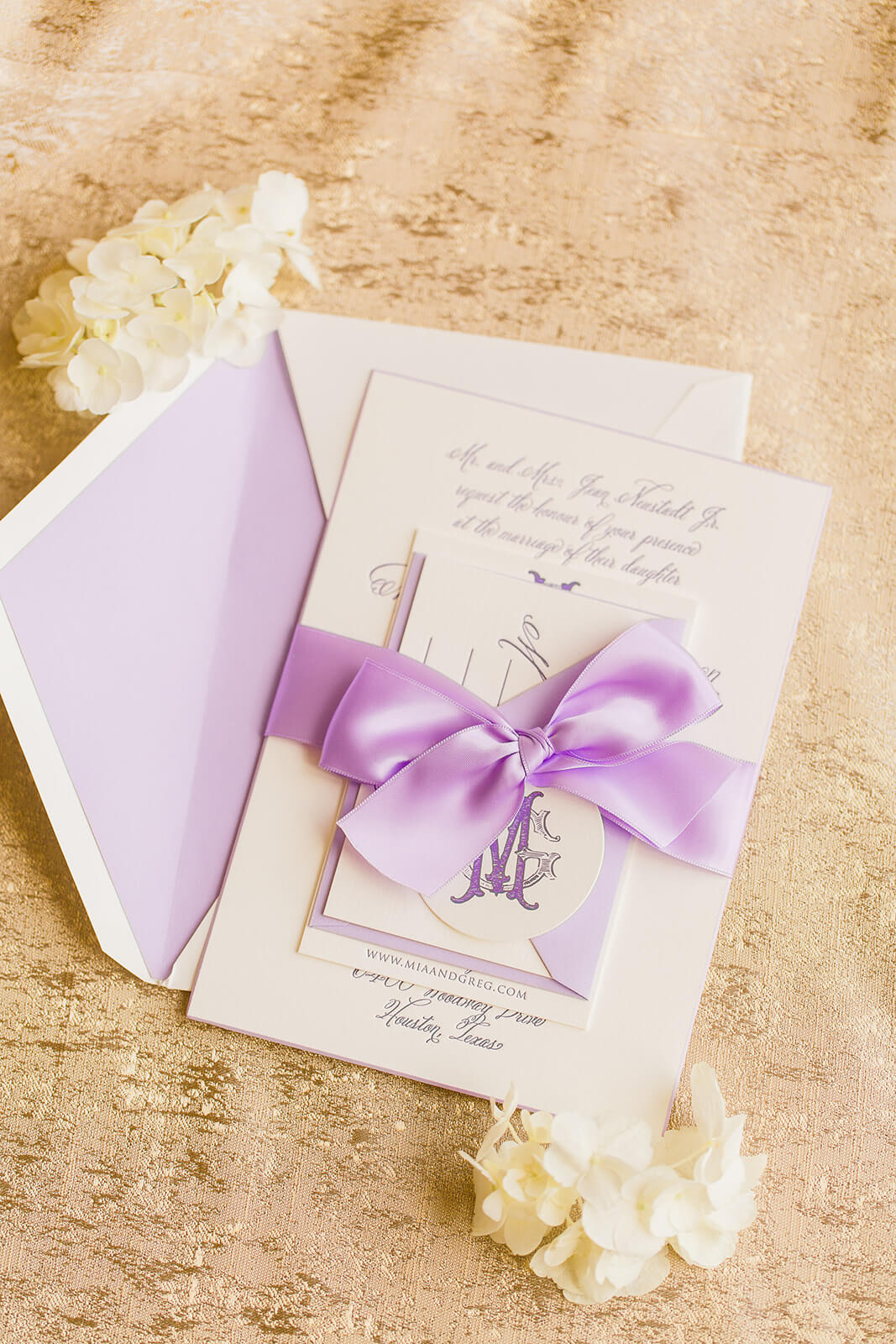 Lovely lavender letterpress wedding invitation with bow